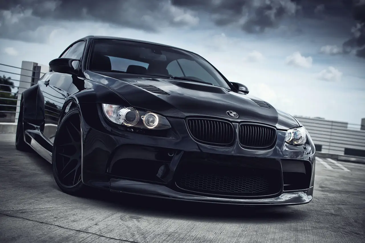 Black performance coupe photographed from the front