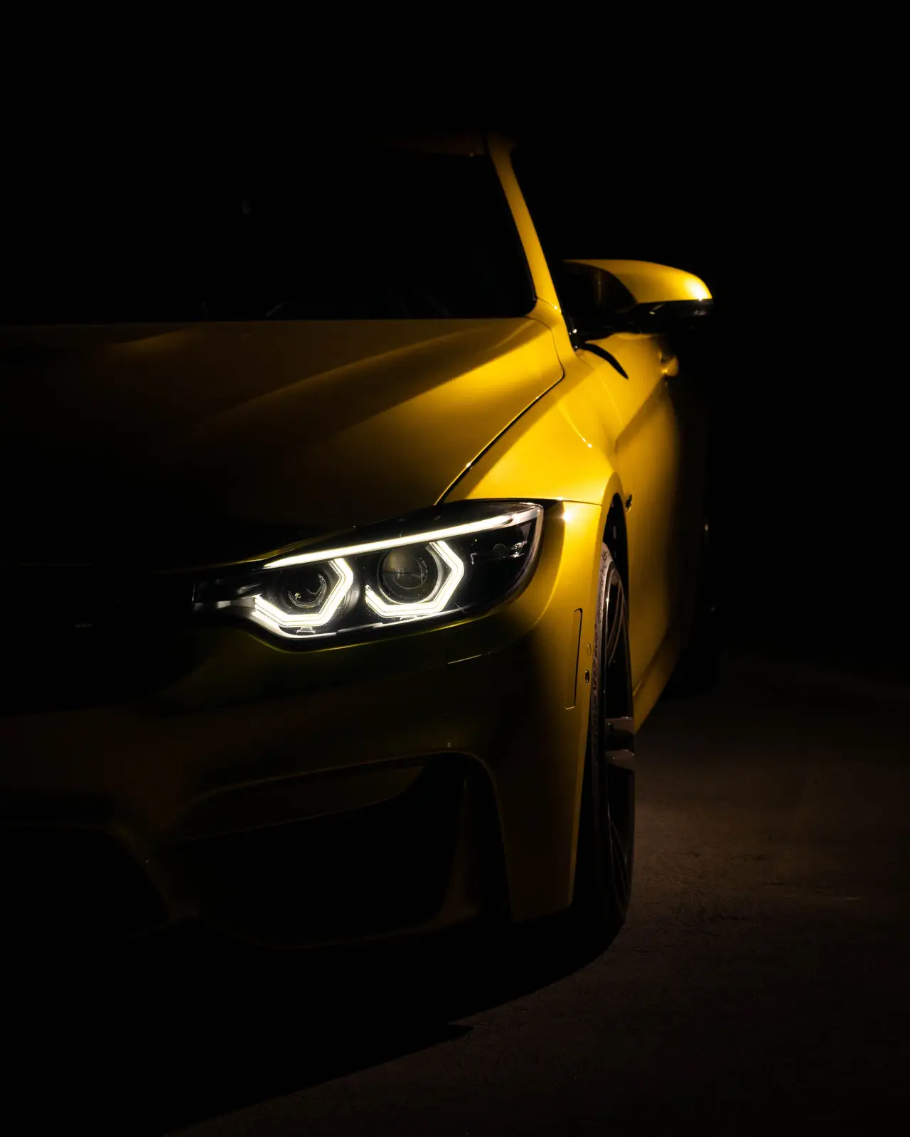 Performance vehicle illuminated in a dark technical setting
