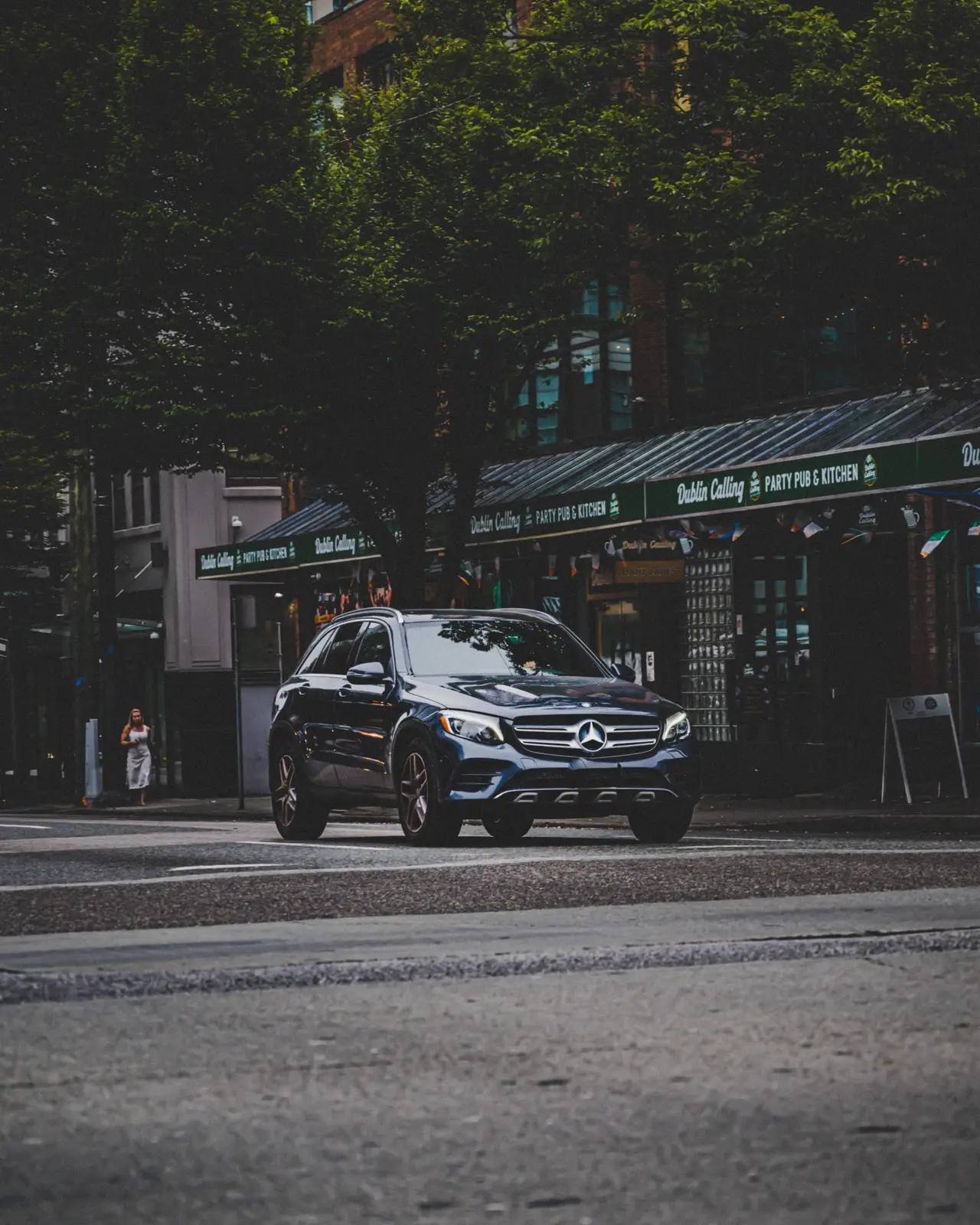Black Mercedes van in a city setting