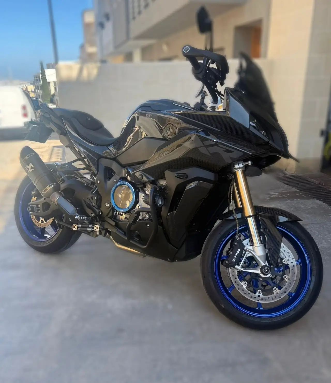 Black performance motorcycle with blue wheel details