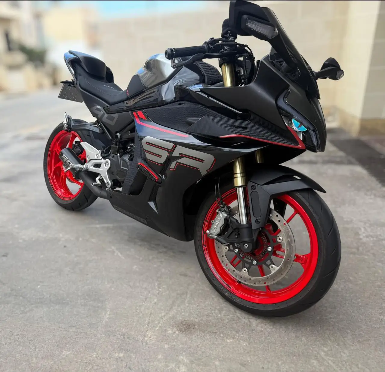 Black sport motorcycle with red wheels