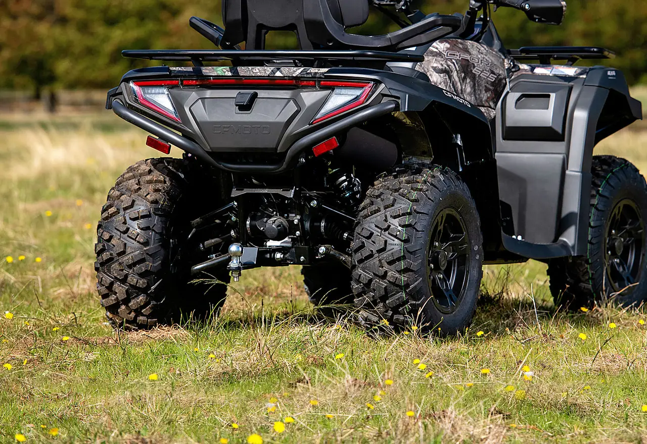 Utility quad driving through open countryside